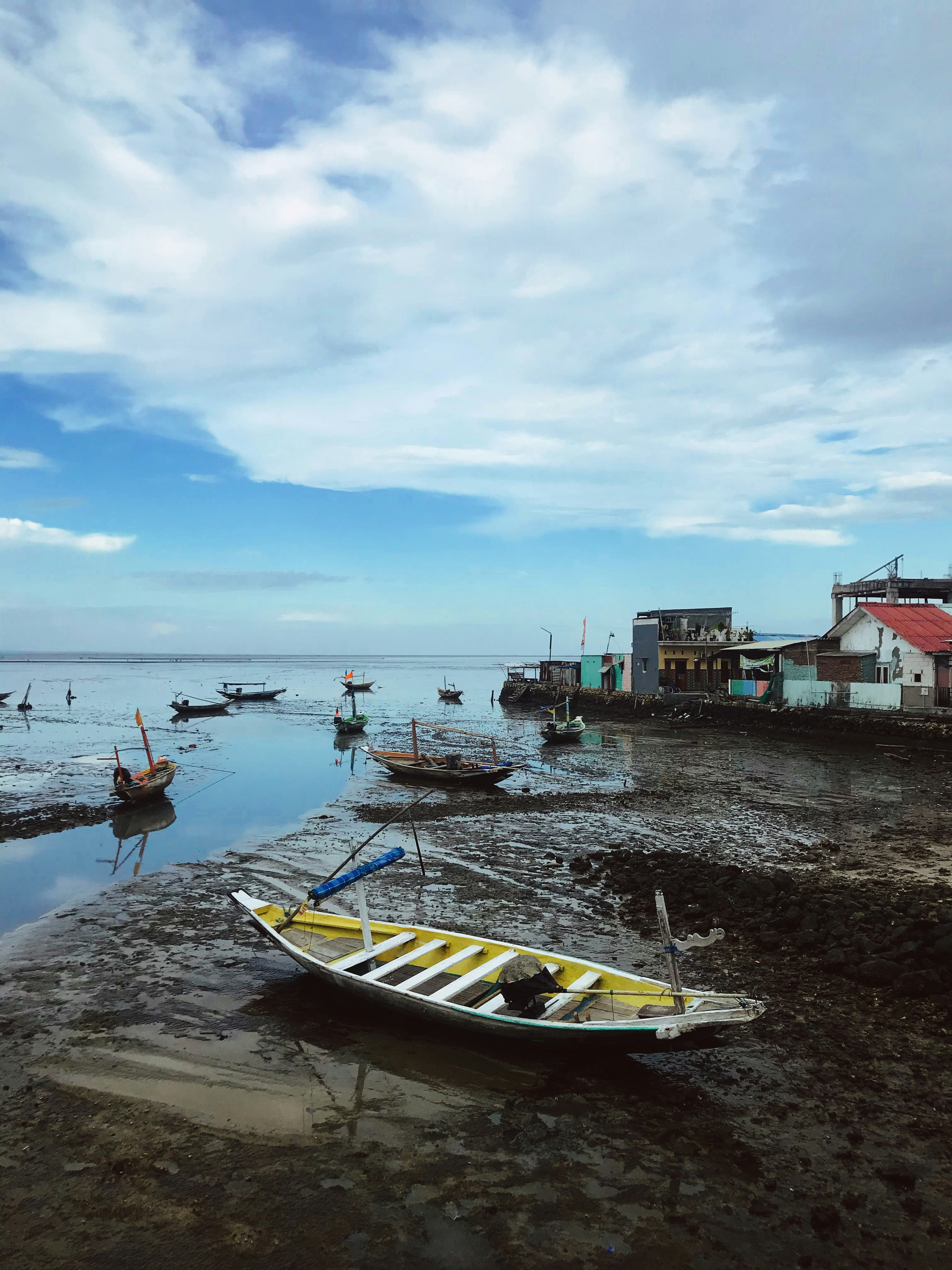 white and red boat on sea shore during daytime